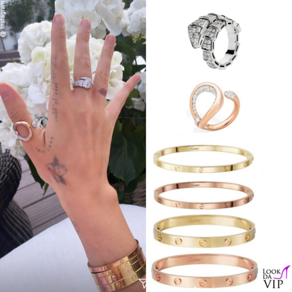 l'anello della collezione Serpenti di Bulgari abbinato a un anello Pomellato e a bracciali Cartier 