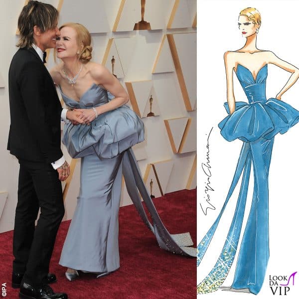 Si tratta di un abito bustier senza spalline in seta azzurra. La silhouette a colonna è accentuata da una gonna a peplo che si lega con un fiocco esagerato e si estende in uno strascico impreziosito da cristalli dorati: ecco il bozzetto di Giorgio Armani