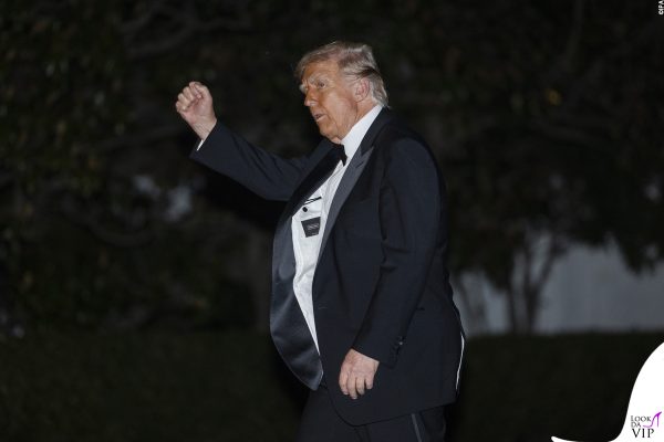 Gesto deciso e pugno alzato: Trump in smoking Made in Italy si mostra sicuro di sé.